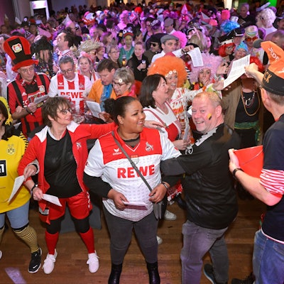 Die verkleideten Menschen singen und schunkeln.