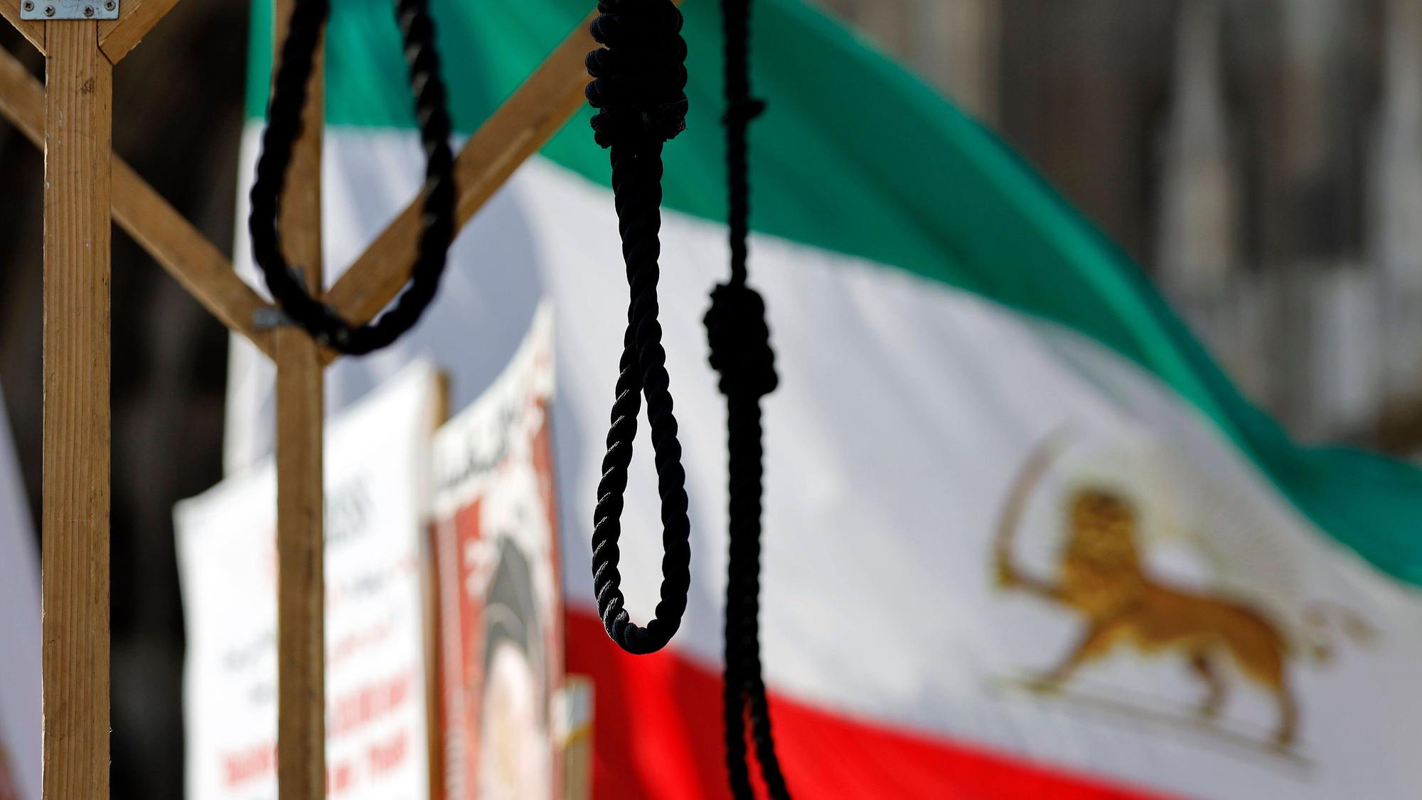 Eine Demonstration von Gegnern des Mullah-Regimes in Teheran fordert Solidarität mit der Opposition im Iran, die Abschaffung der Todesstrafe und einen Umsturz. Sie halten iranische Flaggen und haben einige Galgen aus Holz aufgebaut, welche die martiallschen Hinrichtungsmethoden im Iran veranschaulichen sollen.