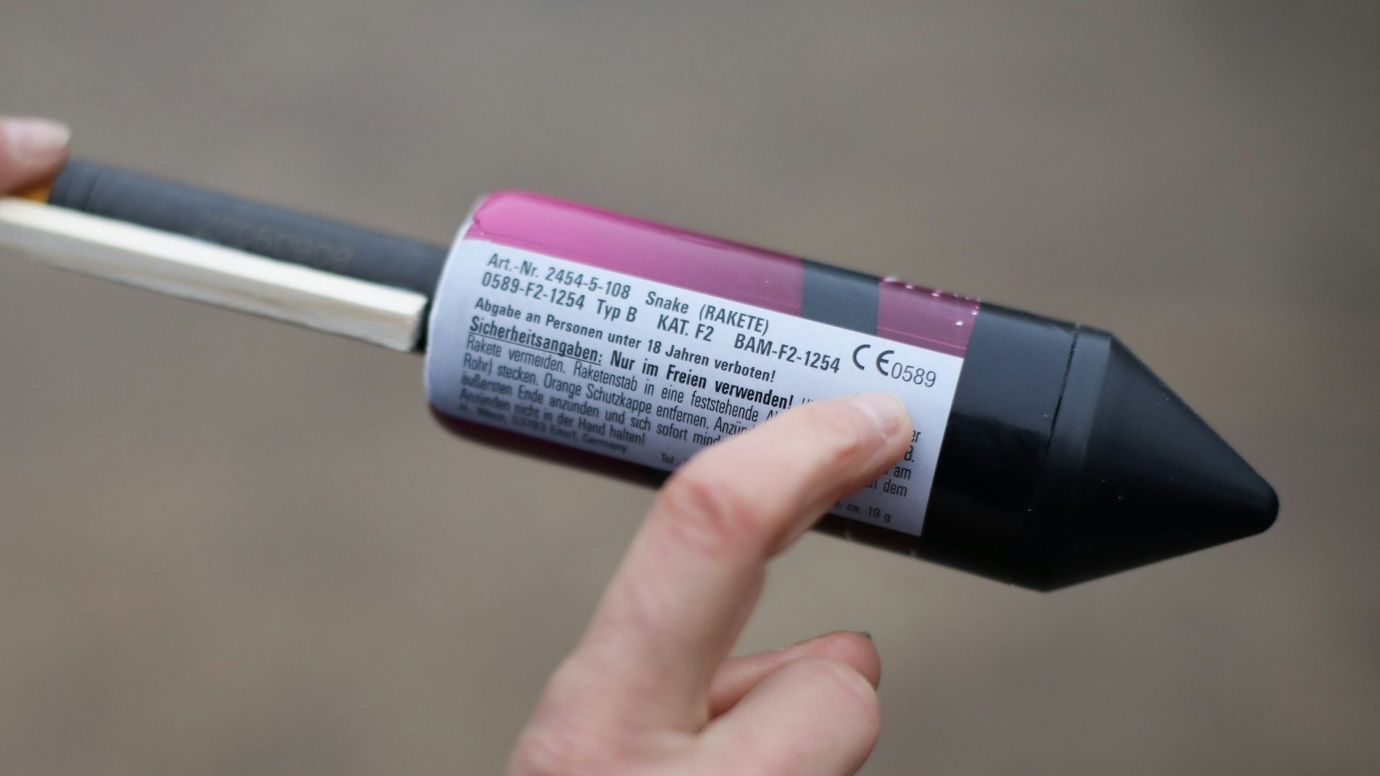 Ein Zeigefinger zeigt auf das CE-Zeichen auf einer Feuerwerksrakete.