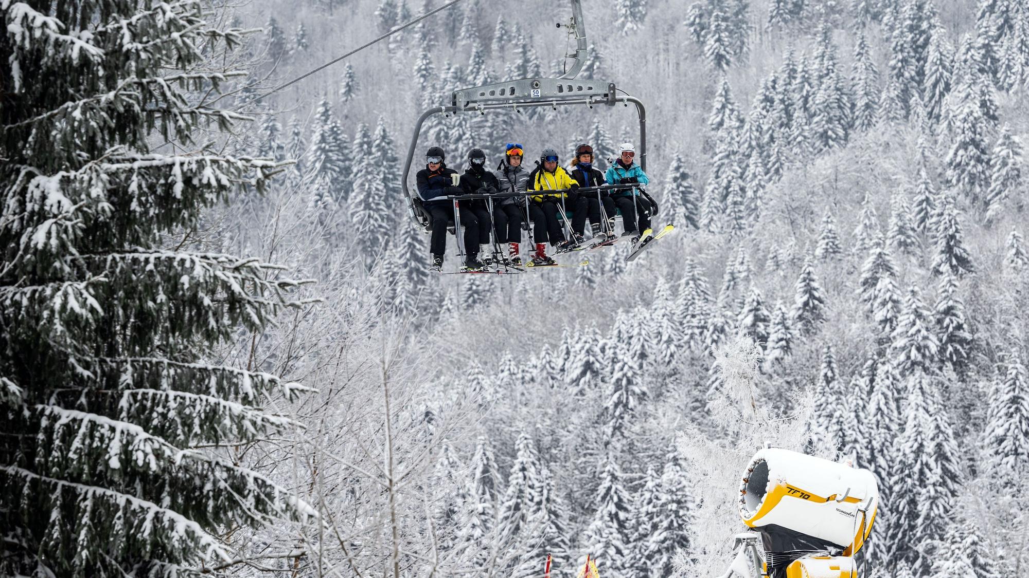 Winterberg: Skifahrer bei winterlichem Wetter in einem Sessellift