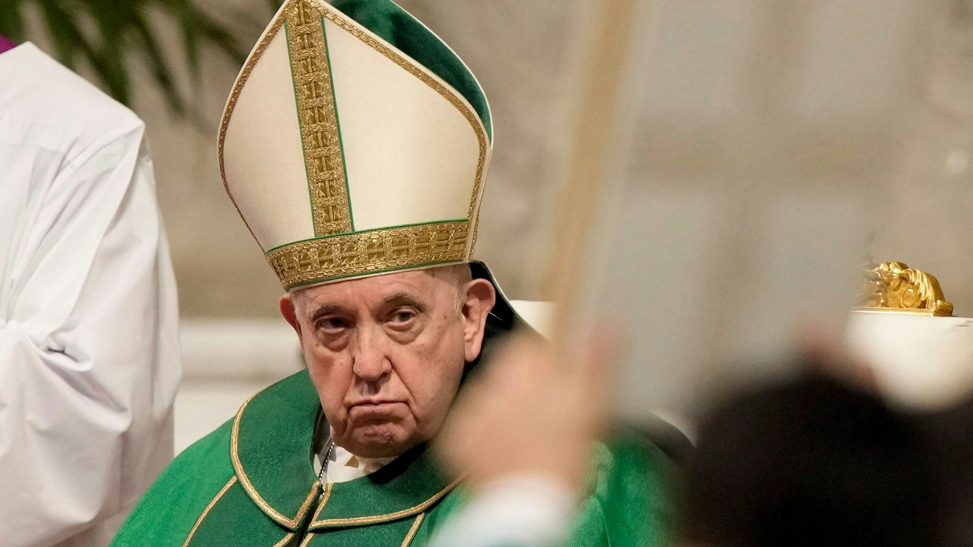 Papst Franziskus blickt während der Messe zum „Tag des Wortes Gottes“ im Petersdom in Rom auf ein hochgehaltenes Evangeliar,