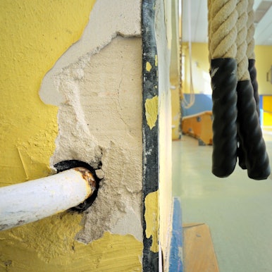 Kinder treiben Sport in einer baufälligen Turnhalle.