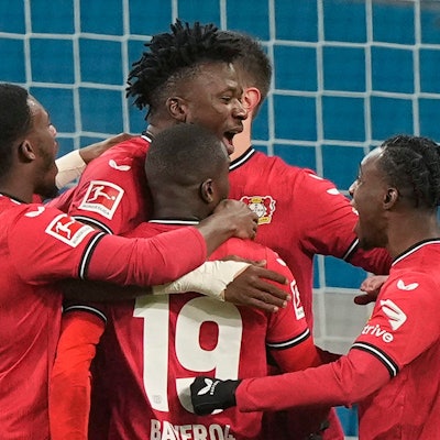 Leverkusen's Edmond Tapsoba, center, is celebrated after he scored a penalty goal during the German Bundesliga soccer match between Bayer Leverkusen and VfL Bochum in Leverkusen, Germany, Germany, Wednesday, Jan. 25, 2023. (AP Photo/Martin Meissner)
