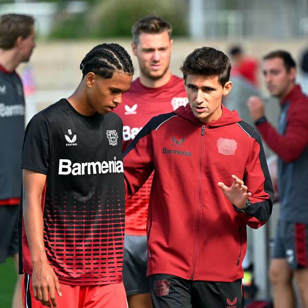 Ein Fußballtrainer spricht mit einem seiner Spieler.