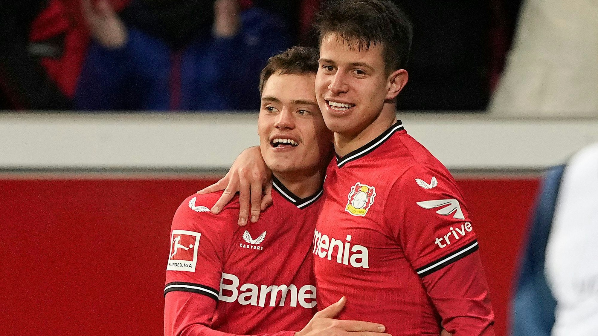 Leverkusen's Adam Hlozak, right, celebrates with Leverkusen's Florian Wirtz after scoring his side's second goal during the German Bundesliga soccer match between Bayer Leverkusen and VfL Bochum in Leverkusen, Germany, Germany, Wednesday, Jan. 25, 2023. (AP Photo/Martin Meissner)