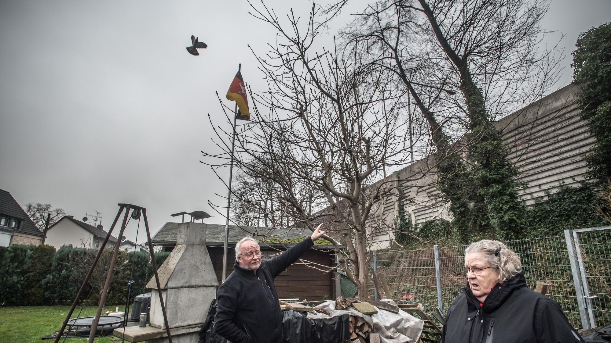 Gisela Kronenberg im Garten von Rolf Luxem (Ratherkämp 8): zwei meter höher als die alte Lärmschutzmauer wird die neue Mauer, höher als die Fahnenstange sie stünde mitten im garten (etwa beim Trampolin). Foto: Ralf Krieger