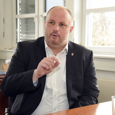 Ein Mann sitzt in einem Büro an einem Tisch.