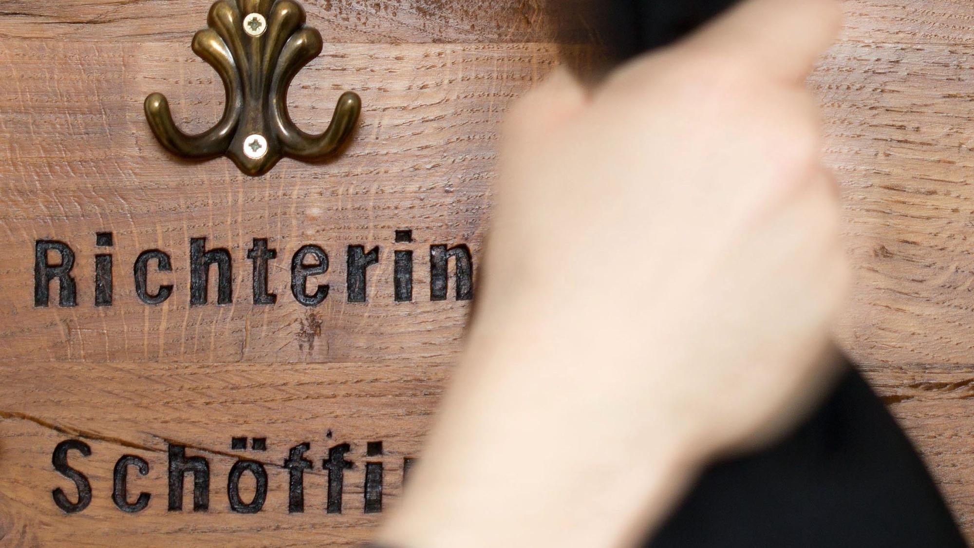 Ein Richter hängt seine Robe am im an eine Garderobe für Richter und Schöffen.