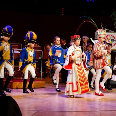Das Kinderdreigestirn steht auf der Bühne der Kölner Philharmonie.
