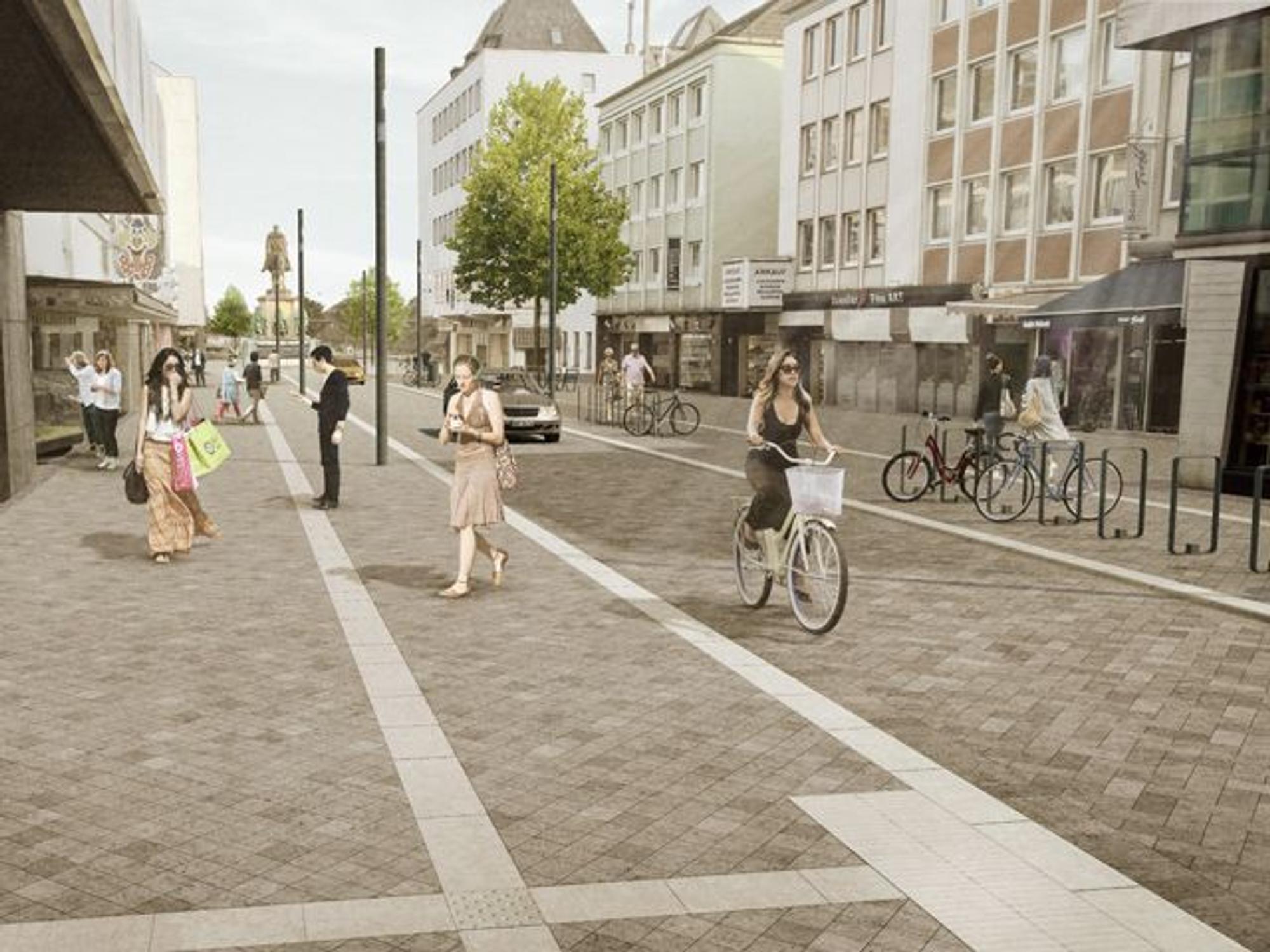 Visualisierung der umgestalteten und städtebaulich aufgewerteten Gürzenichstraße mit Blick auf den Heumarkt. Zu sehen sind flanierende Menschen, Radfahrende, ein Auto und Fahrradabstellanlagen.