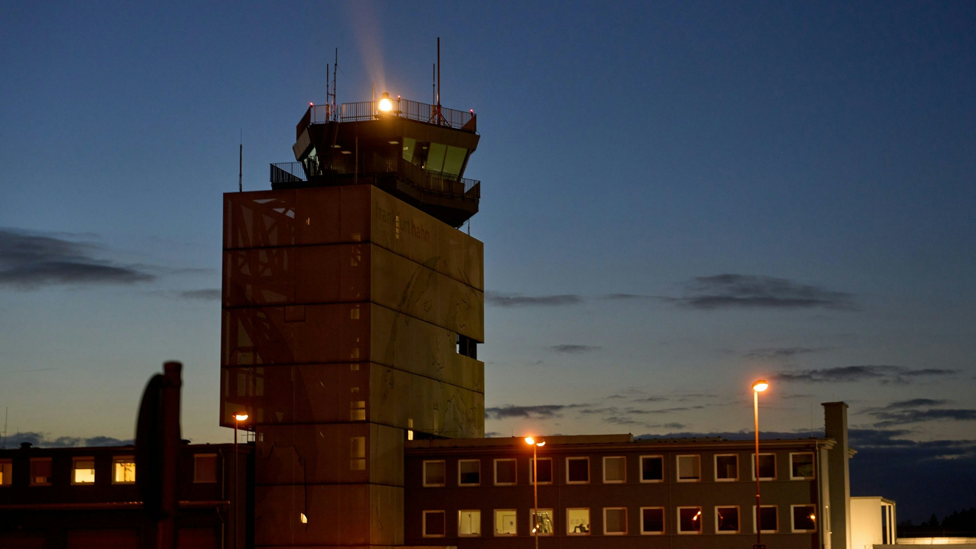Rheinland-Pfalz, Hahn: Ein Drehfeuer auf dem Tower des Flughafens Hahn leuchtet in den Abendhimmel.