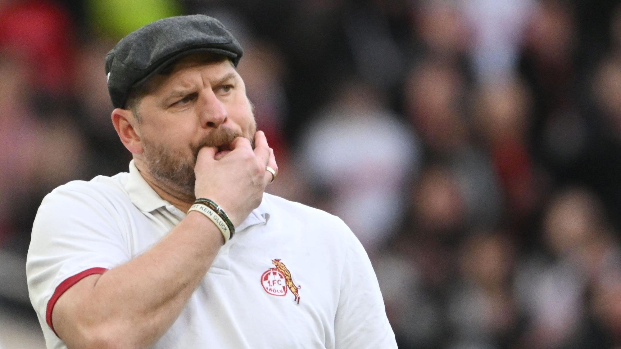 Steffen Baumgart pfeift mit seinen Fingern am Seitenrand