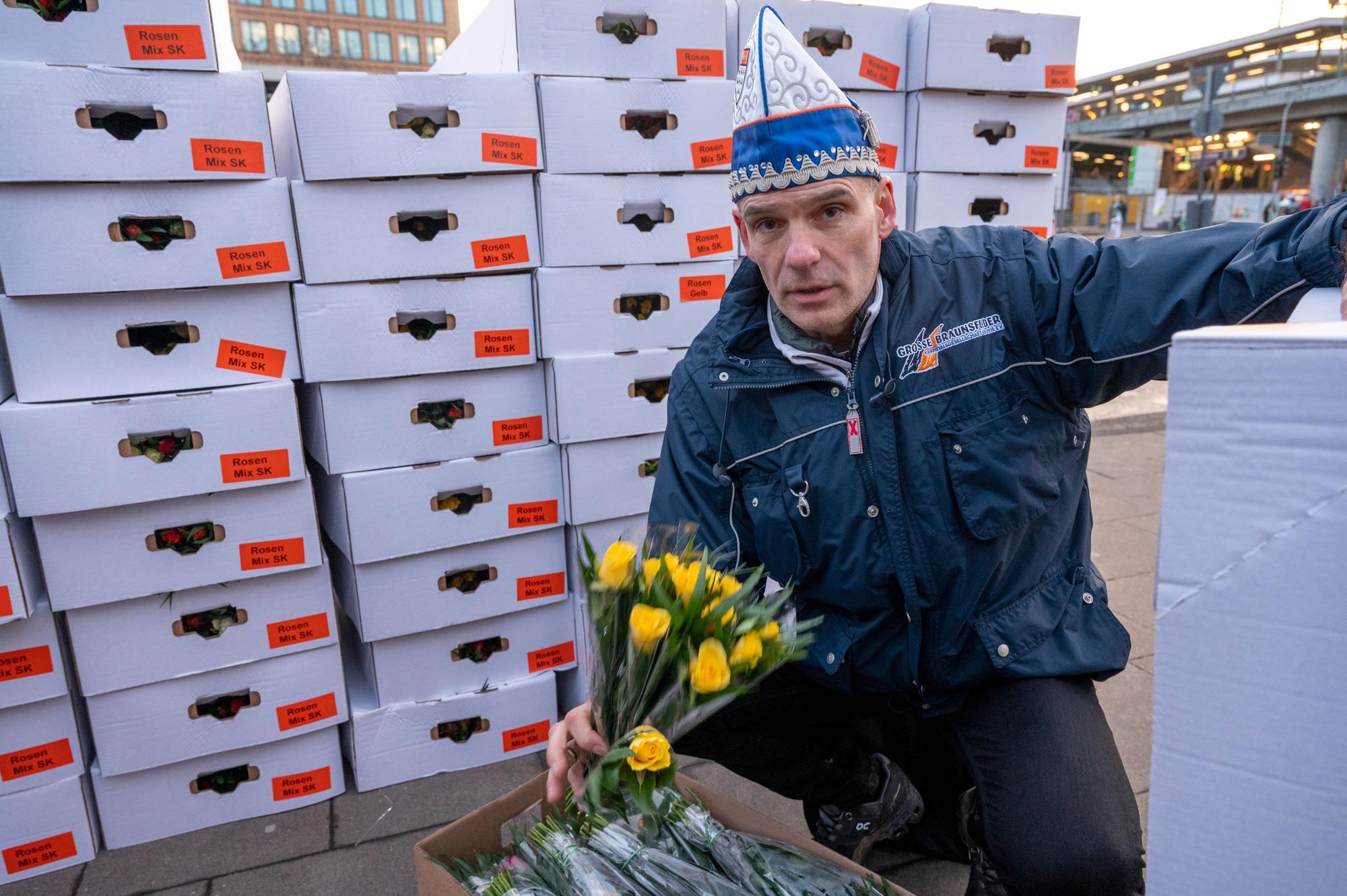 Roland Blaum mit einem Bund gelber Rosen in der Hand,