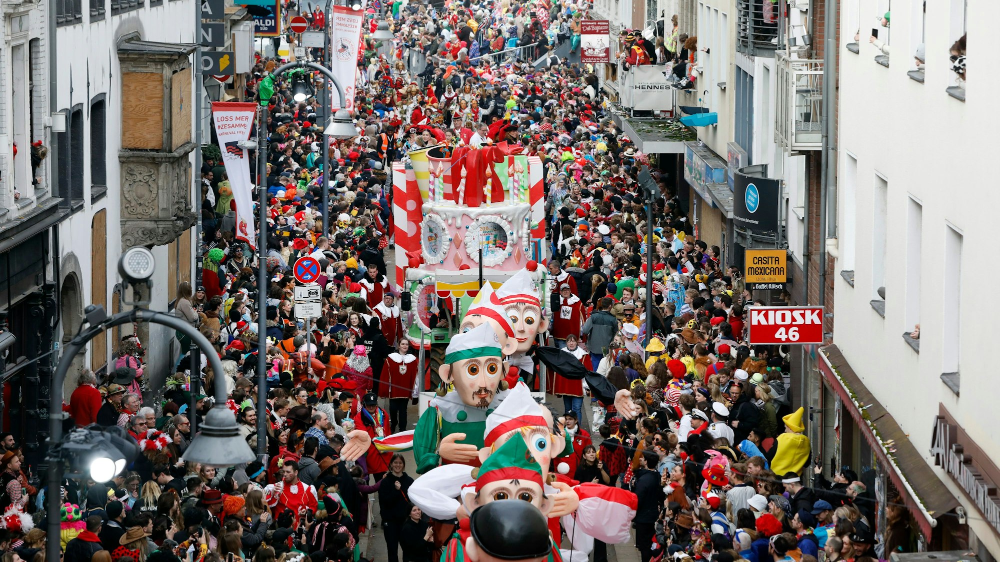 Eine Menschenmenge begleitet den Rosenmontagszug in der Kölner Innenstadt.