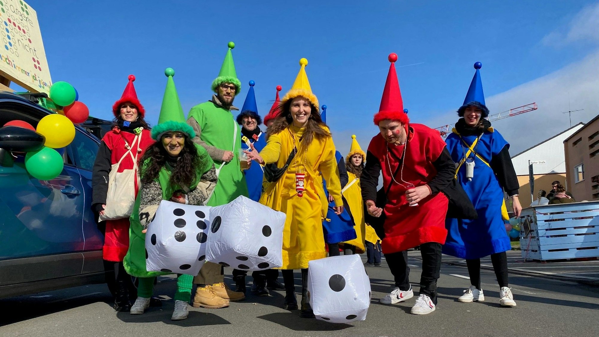 Die bunte Gruppe (grün, gelb, rot und blau) wirft mit aufblasbaren Würfeln.
