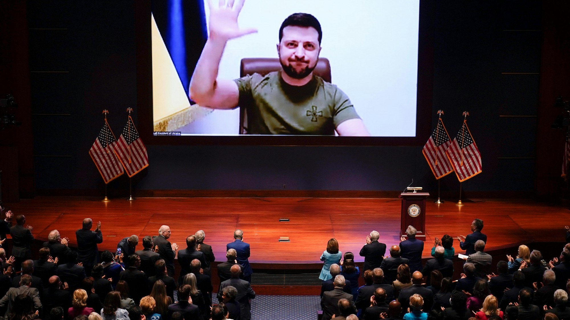 Mitglieder des US-Kongresses geben Wolodymyr Selenskyj (Monitor), Präsident der Ukraine, stehende Ovationen, während er grüßt.