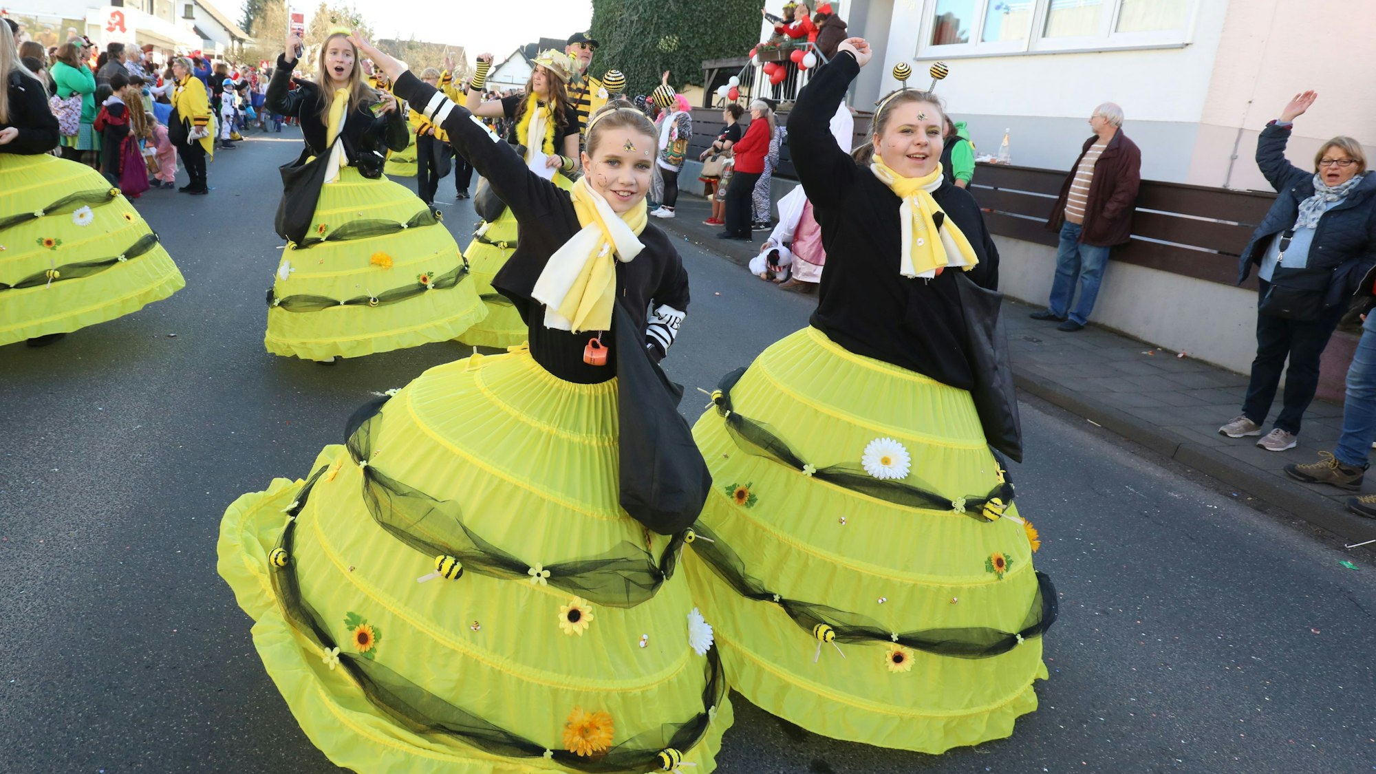 Zwei junge Frauen in schwarz-gelben Kostümen sind als Bienen verkleidet.