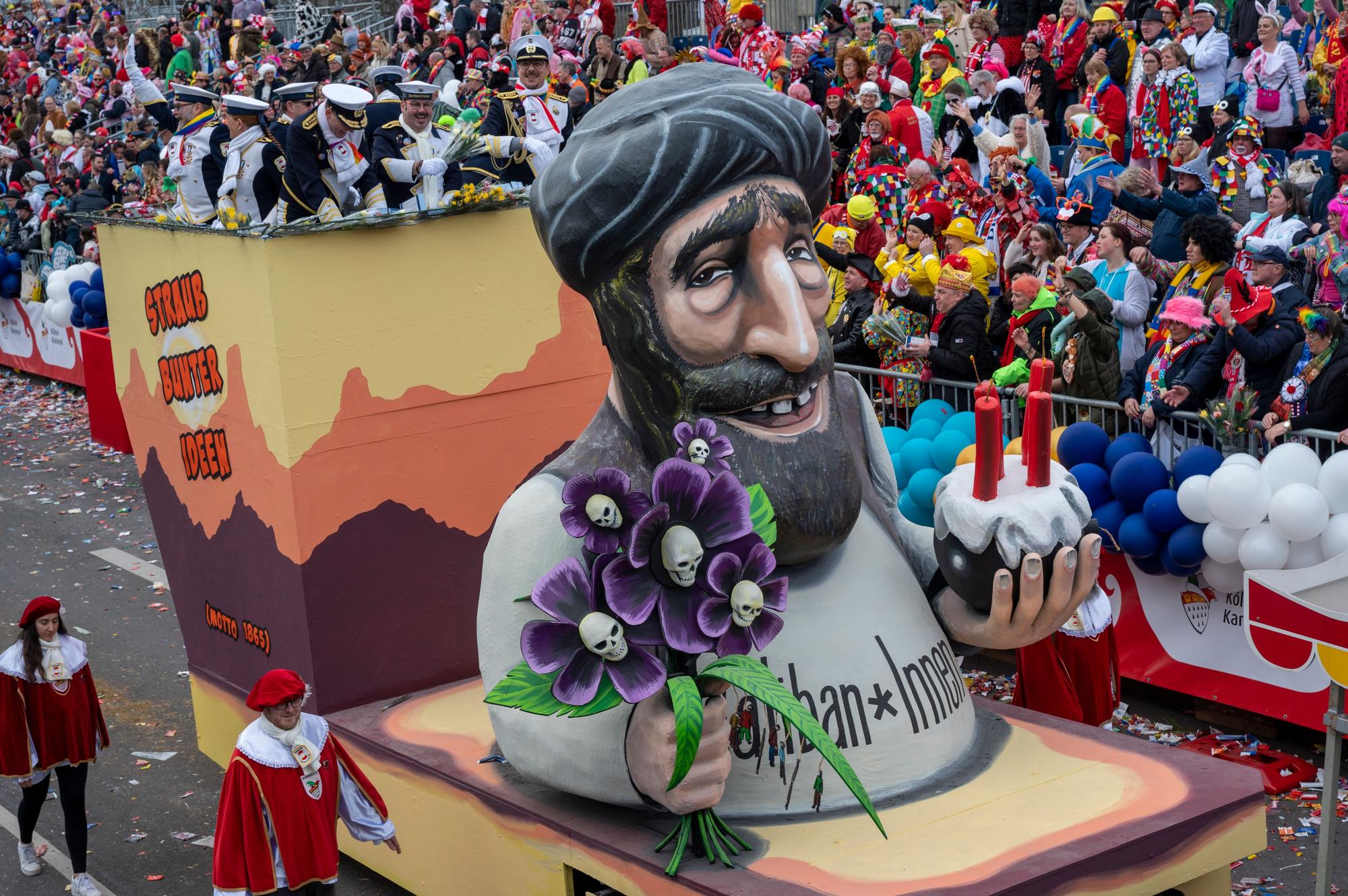 Eine Talibanfigur mit einem Strauß Blumen und einer Bombe in den Händen.