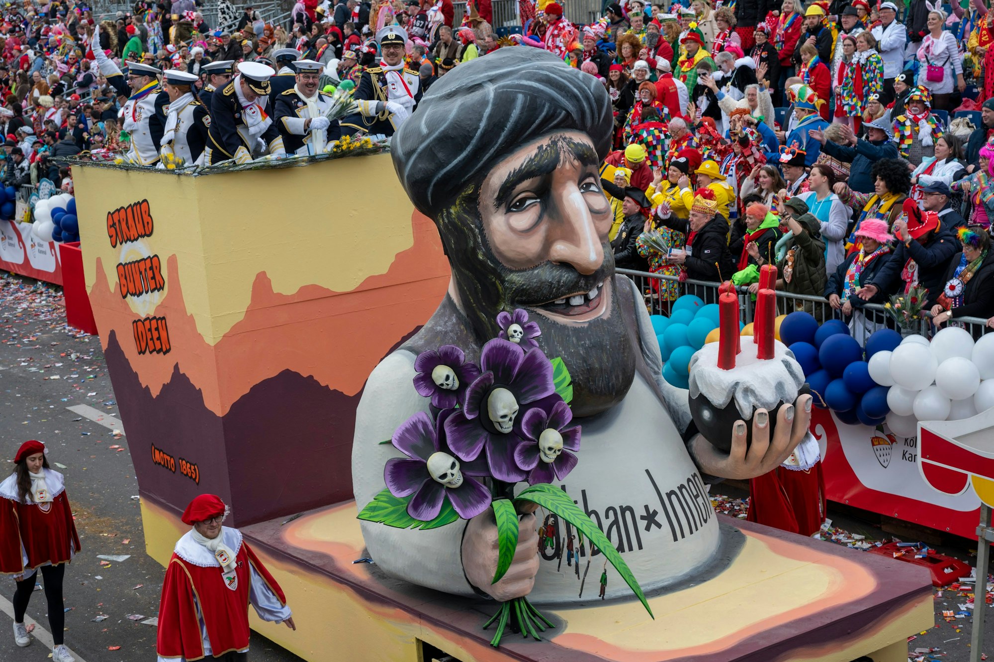 Eine Talibanfigur mit einem Strauß Blumen und einer Bombe in den Händen.