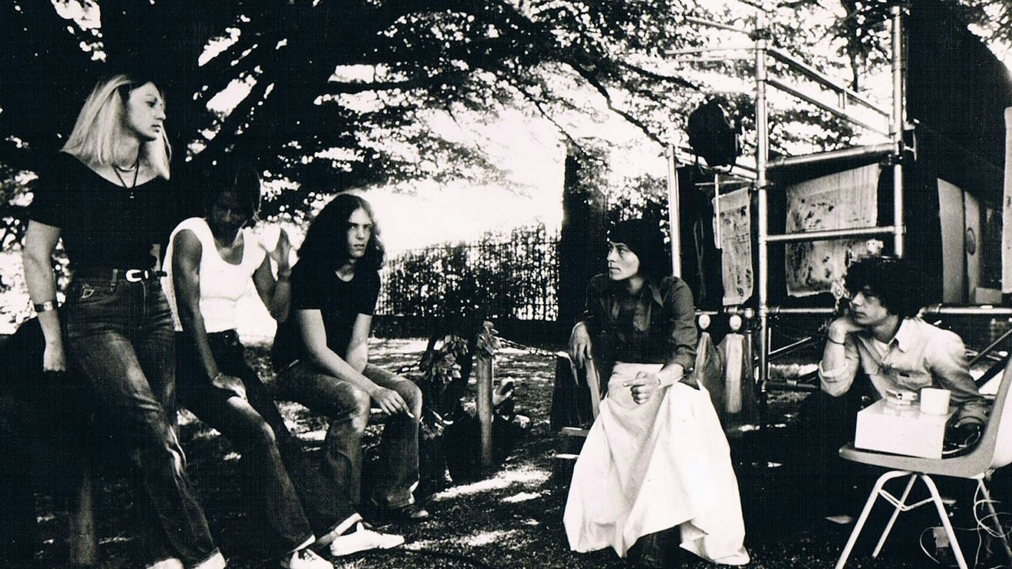 Menschen sitzen auf einem Schwarz-Weiß-Foto zusammen.