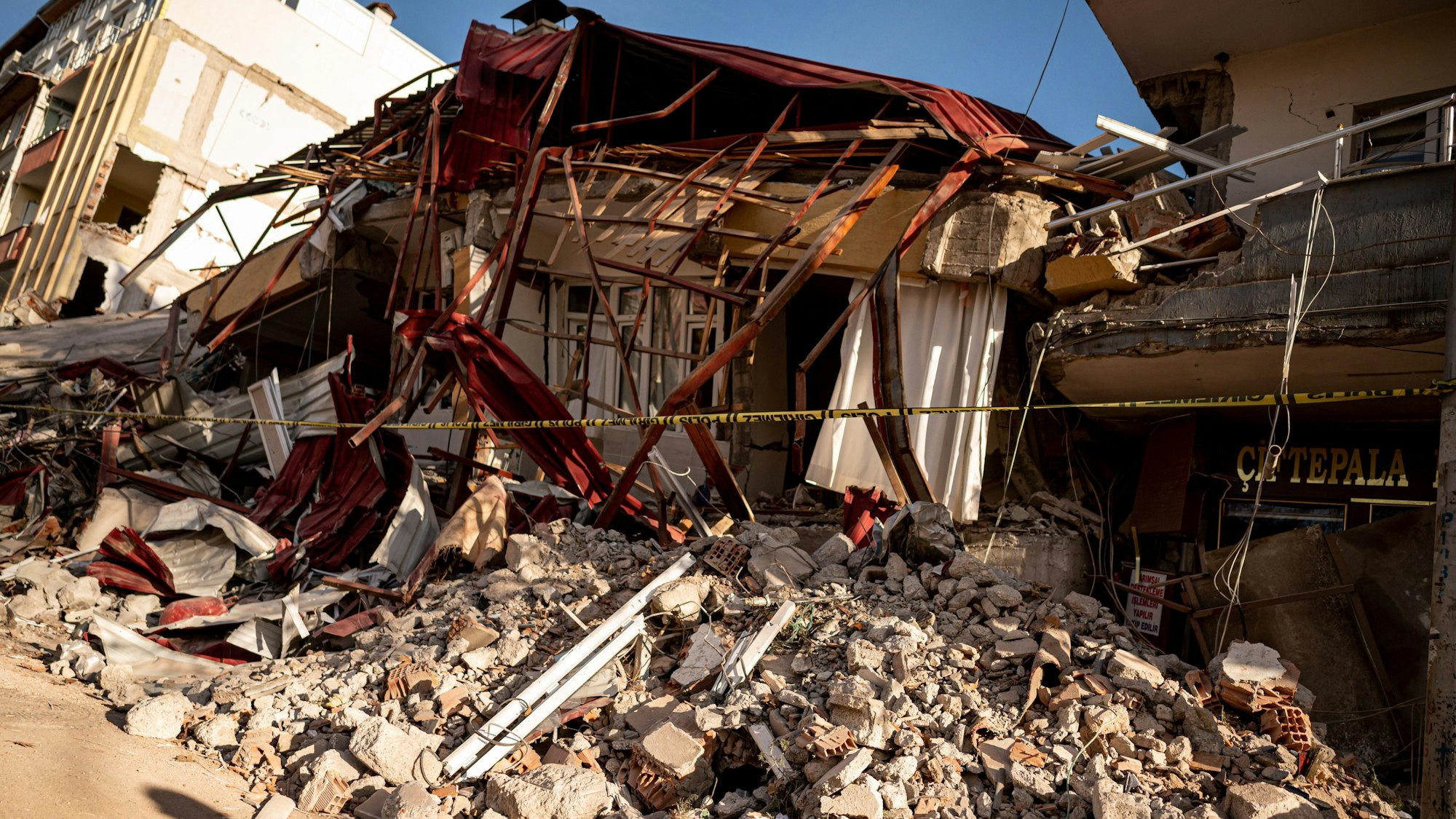 21.02.2023, Türkei, Pazarcik: Trümmer eines zusammengestürzten Haus liegen in der vom Erdbeben schwer getroffene Stadt Pazarcik in der Region Kahramanmaras.