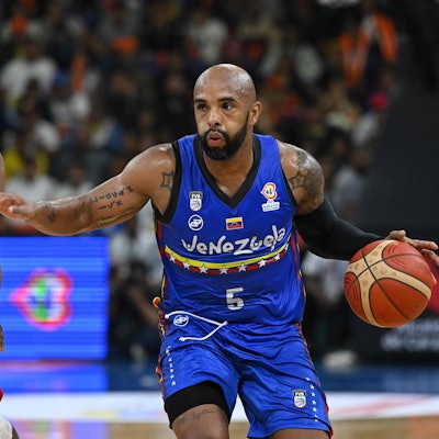 Canada's Kadre Gray (L) marks Venezuela's Gregory Vargas during their FIBA Basketball World Cup 2023 Americas qualifiers match at the Poliedro in Caracas , on February 26, 2023. - fouls (Photo by Federico PARRA / AFP)