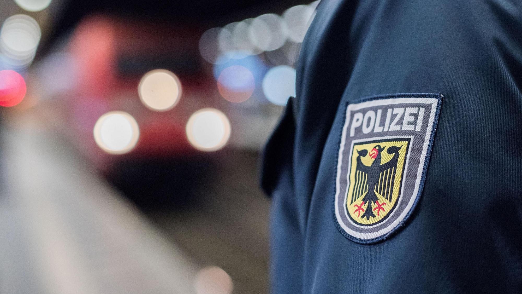 Ein Beamter der Bundespolizei steht am Gleis eines Bahnhofs.