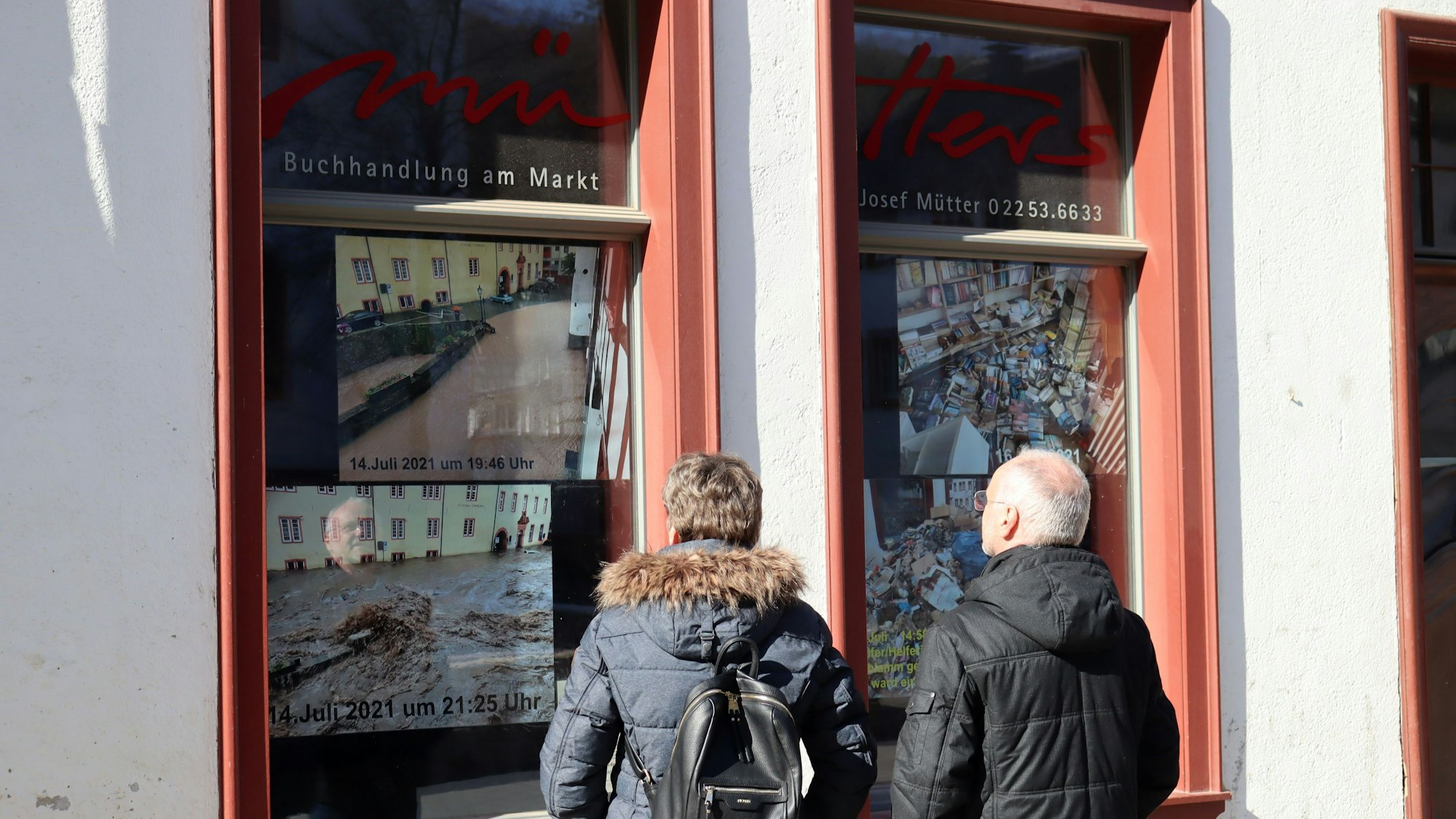 Blickfang: Passanten schauen sich die Fotos der Katastrophe an.