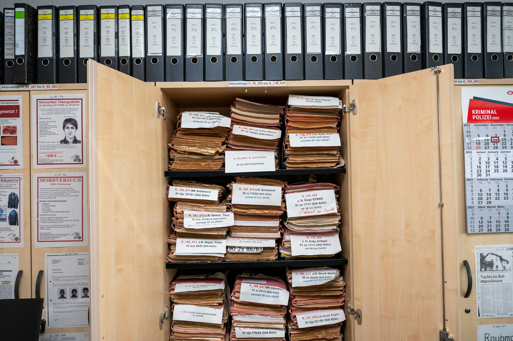 Die Fallakten der Cold Cases liegen im Aktenschrank. Darüber stehen Leitzordner.