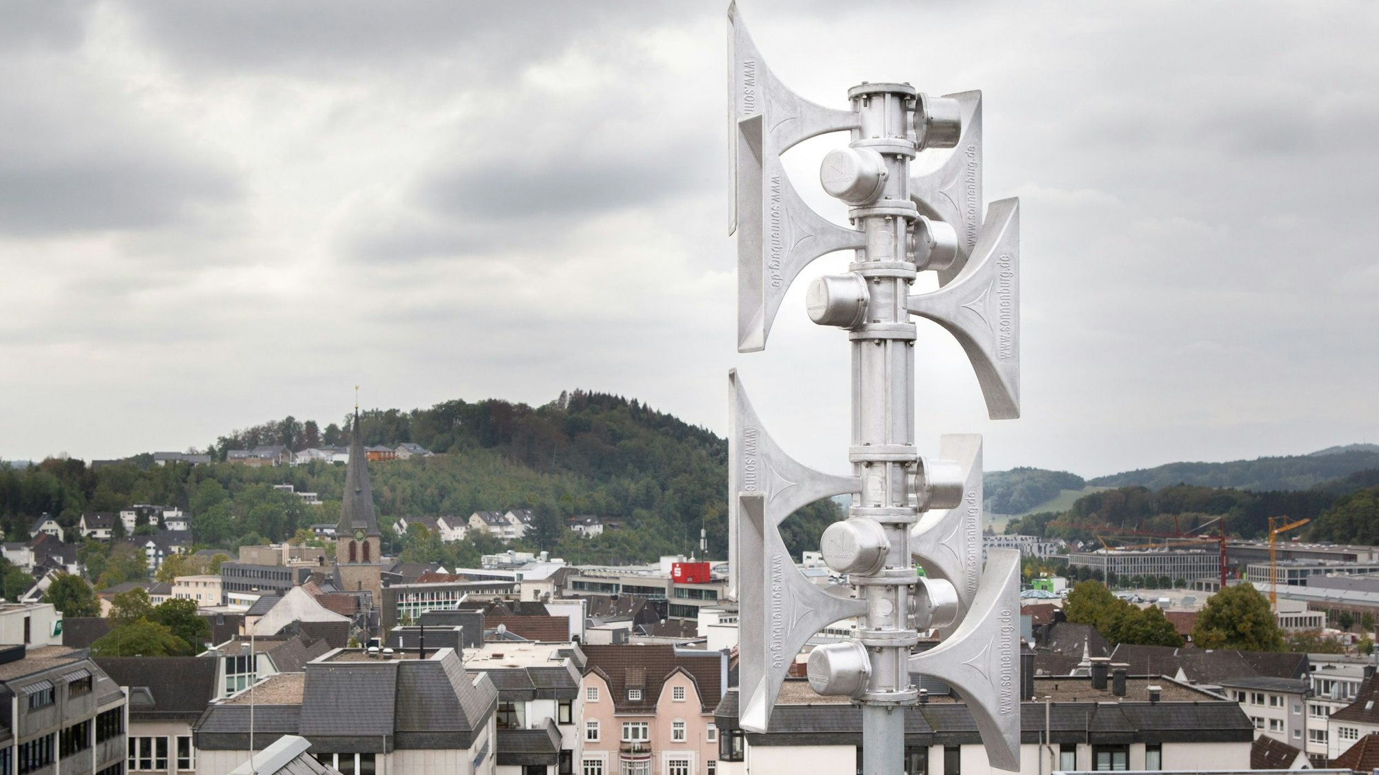 Eine silberne Warnsirene ist auf einem Dach befestigt.