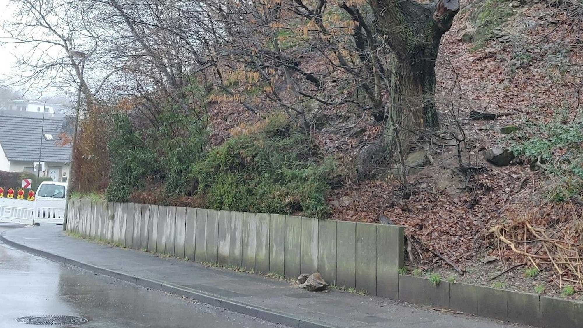 Auf dem Gehweg neben dem Hang liegen wenige Steine von dem Abbruch, der sich am Mittwochabend ereignete.