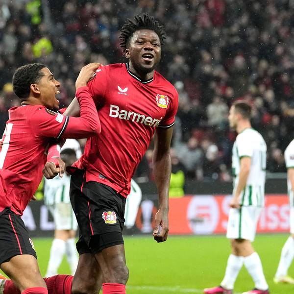 Leverkusen's Edmond Tapsoba, centre, celebrates after scoring his side's second goal during the Europa League Round of 16 first leg soccer match between Bayer Leverkusen and Ferencvaros in Leverkusen, Germany, Thursday, March 9, 2023. (AP Photo/Martin Meissner)