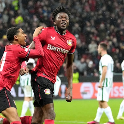 Leverkusen's Edmond Tapsoba, centre, celebrates after scoring his side's second goal during the Europa League Round of 16 first leg soccer match between Bayer Leverkusen and Ferencvaros in Leverkusen, Germany, Thursday, March 9, 2023. (AP Photo/Martin Meissner)