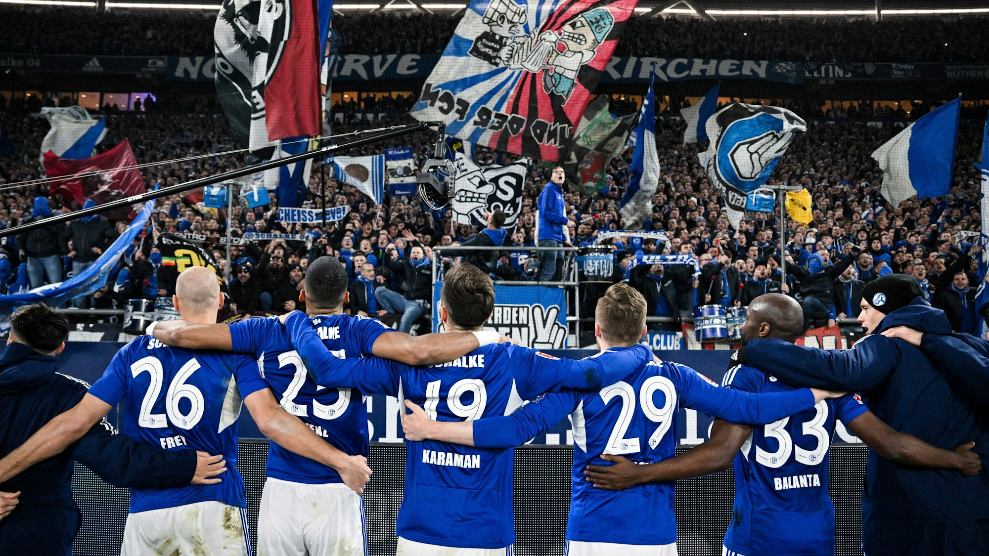 Schalkes Spieler jubeln nach ihrem Sieg gegen Dortmund mit den Fans.