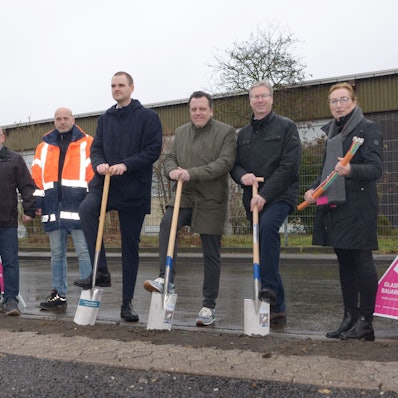 Mit Spaten und Glasfaser in der Hand blicken die Personen in die Kamera.