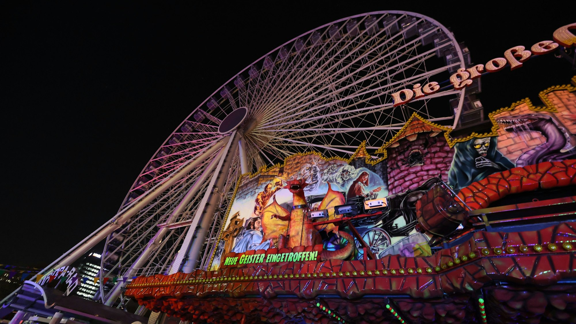 Die Geisterbahn vor dem Riesenrad auf der Deutzer Kirmes im Herbst 2022.