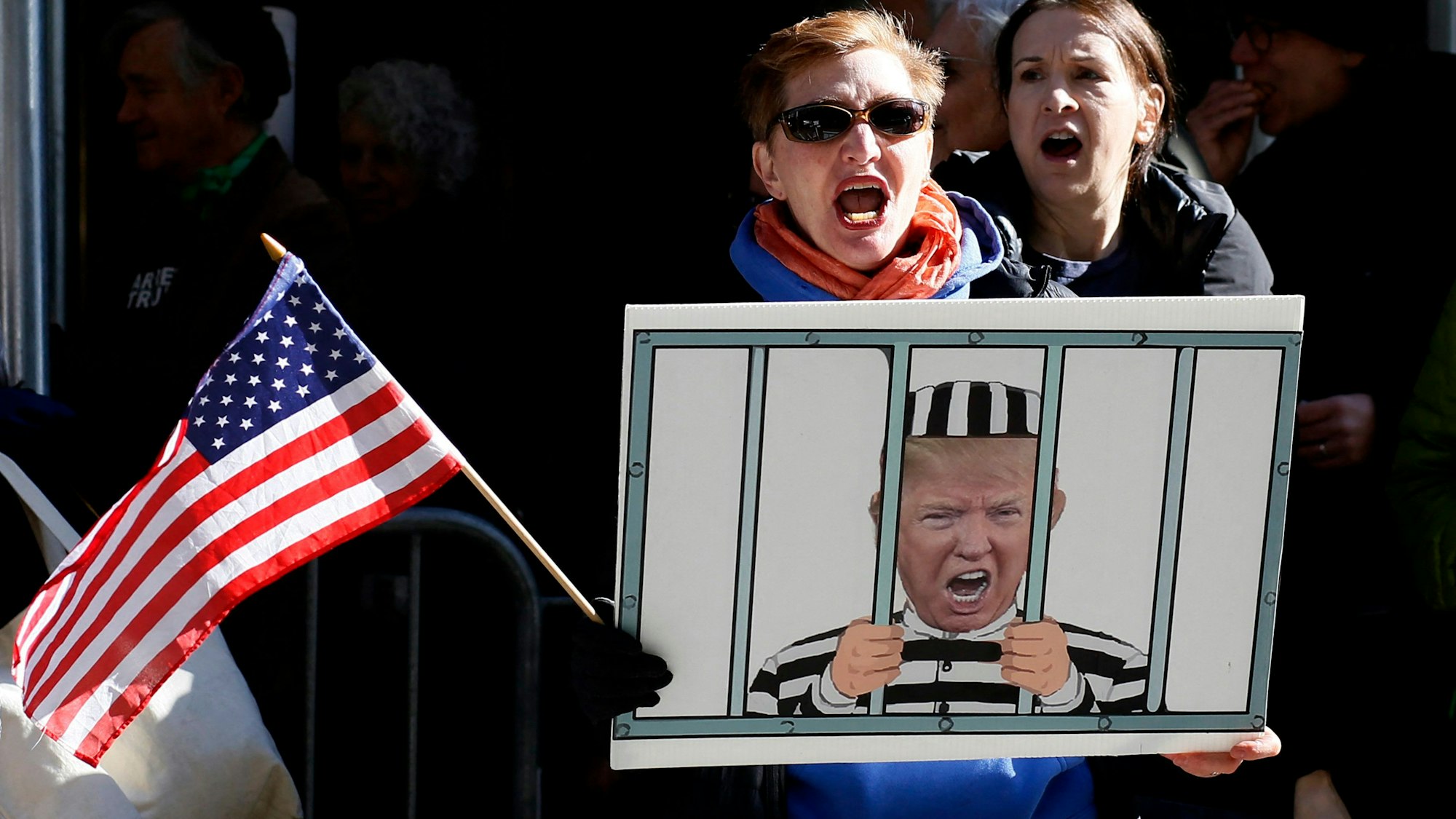 Anti-Trump demonstrators protest outside the Manhattan District Attorney's office in New York City on March 21, 2023