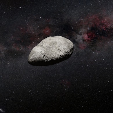 Ein Asteroid im Weltraum nähert sich der Erde.