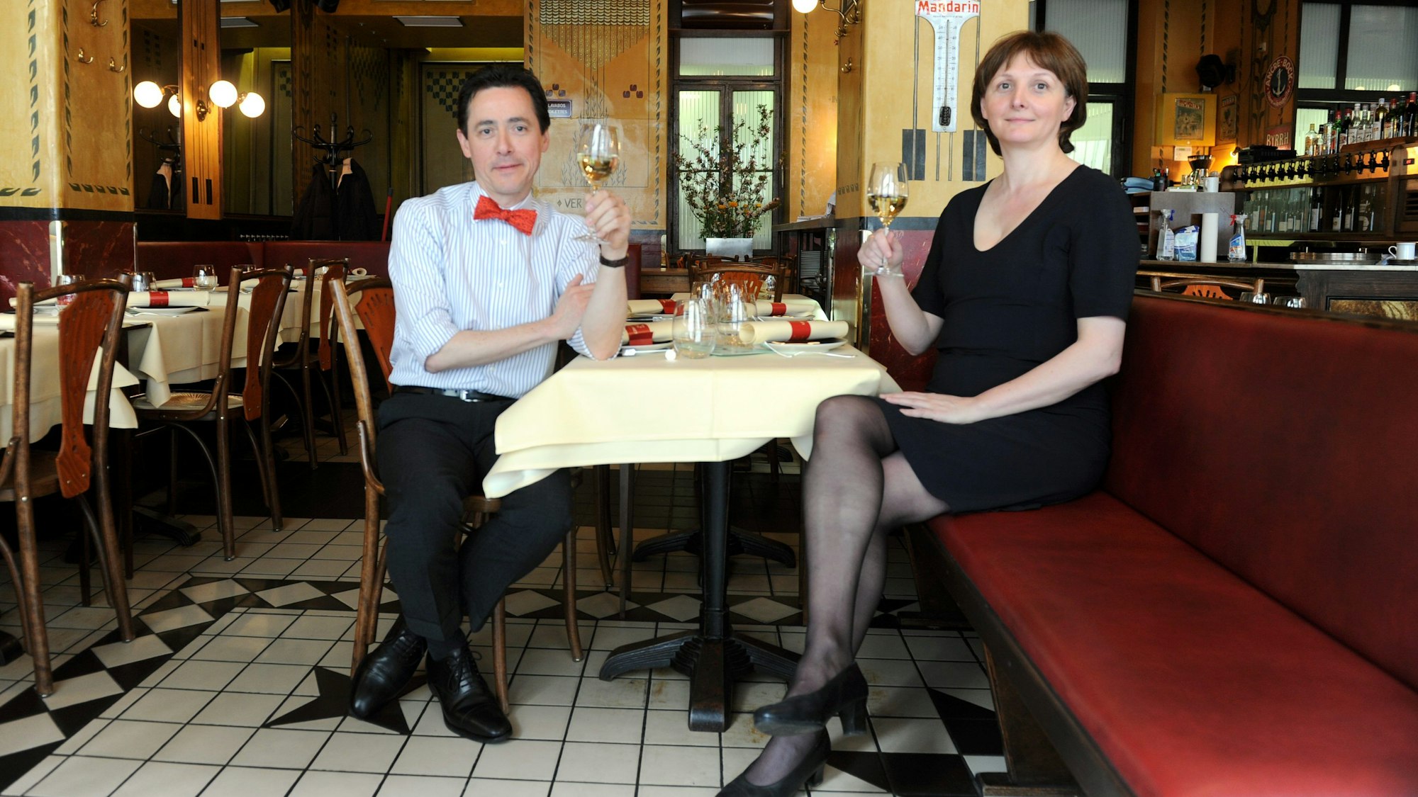 Das Pärchen sitzt an einem Tisch und trinkt Wein.