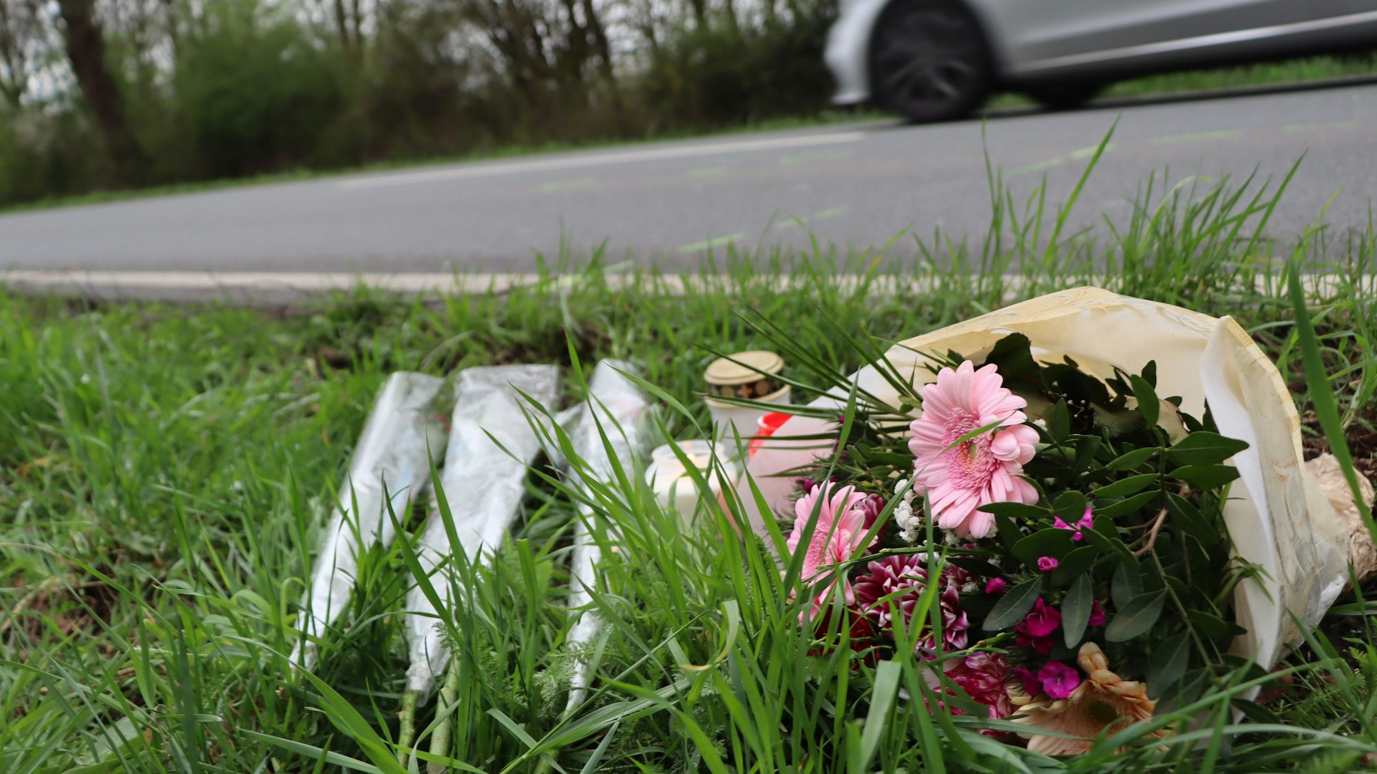 Am Tag nach dem schrecklichen Unfall hatten Menschen an der Rodenkirchener Straße in Wesseling Blumen abgelegt und Kerzen aufgestellt.