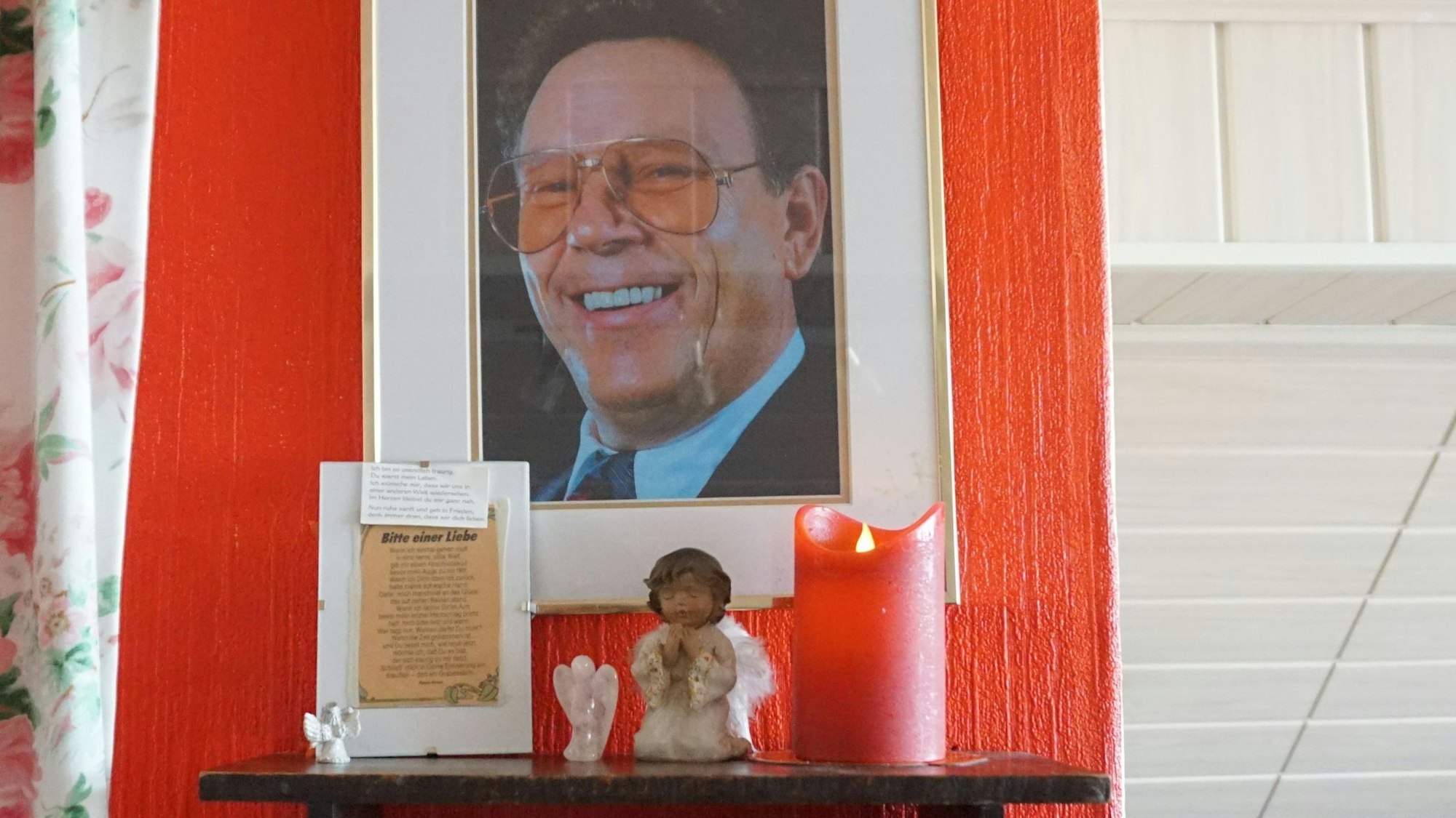 Ein Foto von Heinz Kalterherberg hängt an der Wand, davor eine Kerze und ein kleiner Porzellanengel.