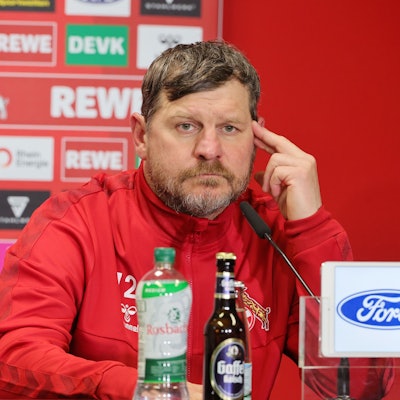 Steffen Baumgart, Trainer des 1. FC Köln, beantwortet auf einer Pressekonferenz Fragen der anwesenden Journalisten. Vor ihm steht ein MIkrofon.