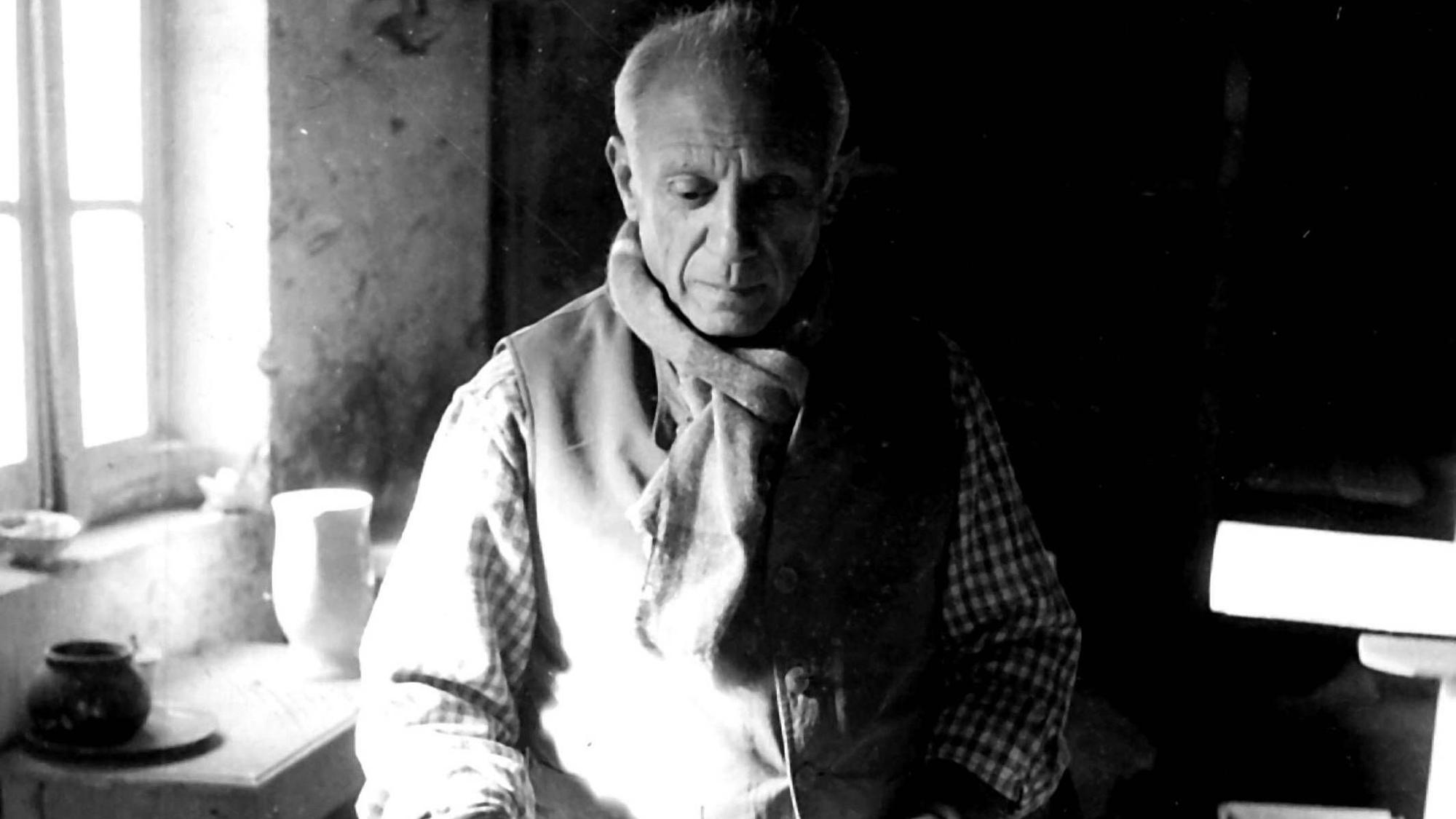 Pablo Picasso schaut sich beim Malen auf die Finger.