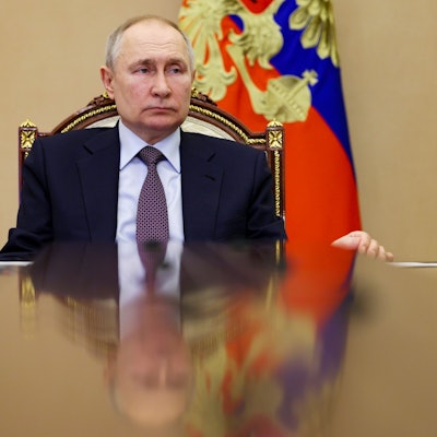 Der russische Präsident Wladimir Putin sitzt an einem Tisch im Kreml. Im Hintergrund ist die russische Flagge zu sehen.