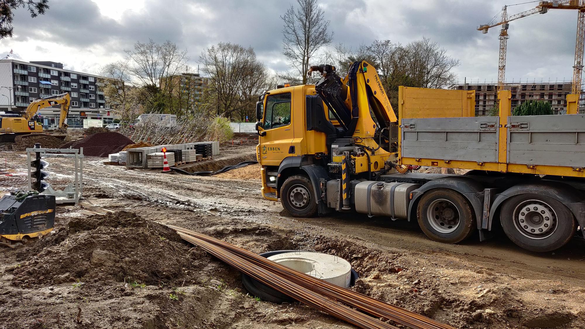 Gelber Lastzug der Baumschule Ebben steht auf der Baustelle im Stadtpark.