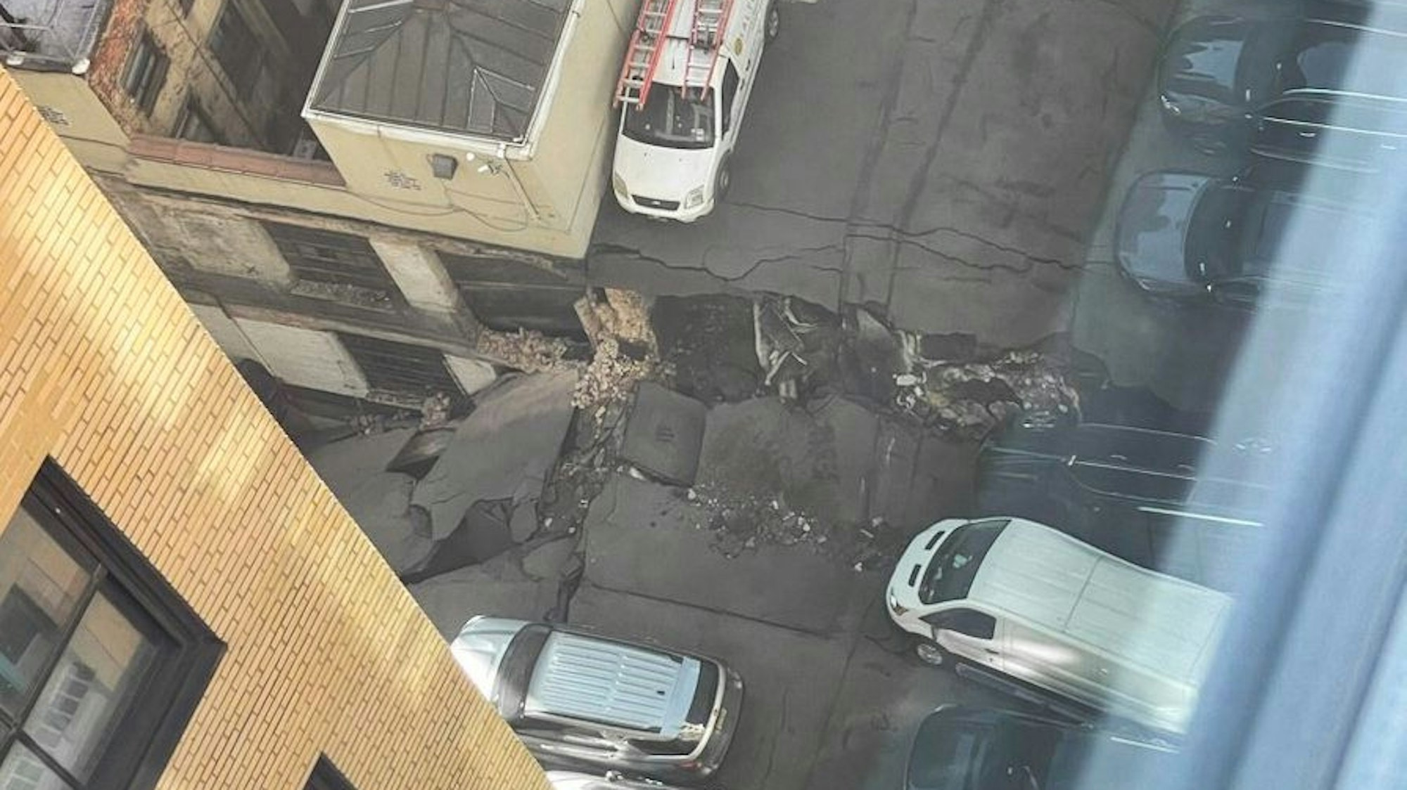 Auf der Aufnahme ist eine große Einbruchsstelle eines Parkhauses mit Rissen aus der Vogelperspektive zu sehen.