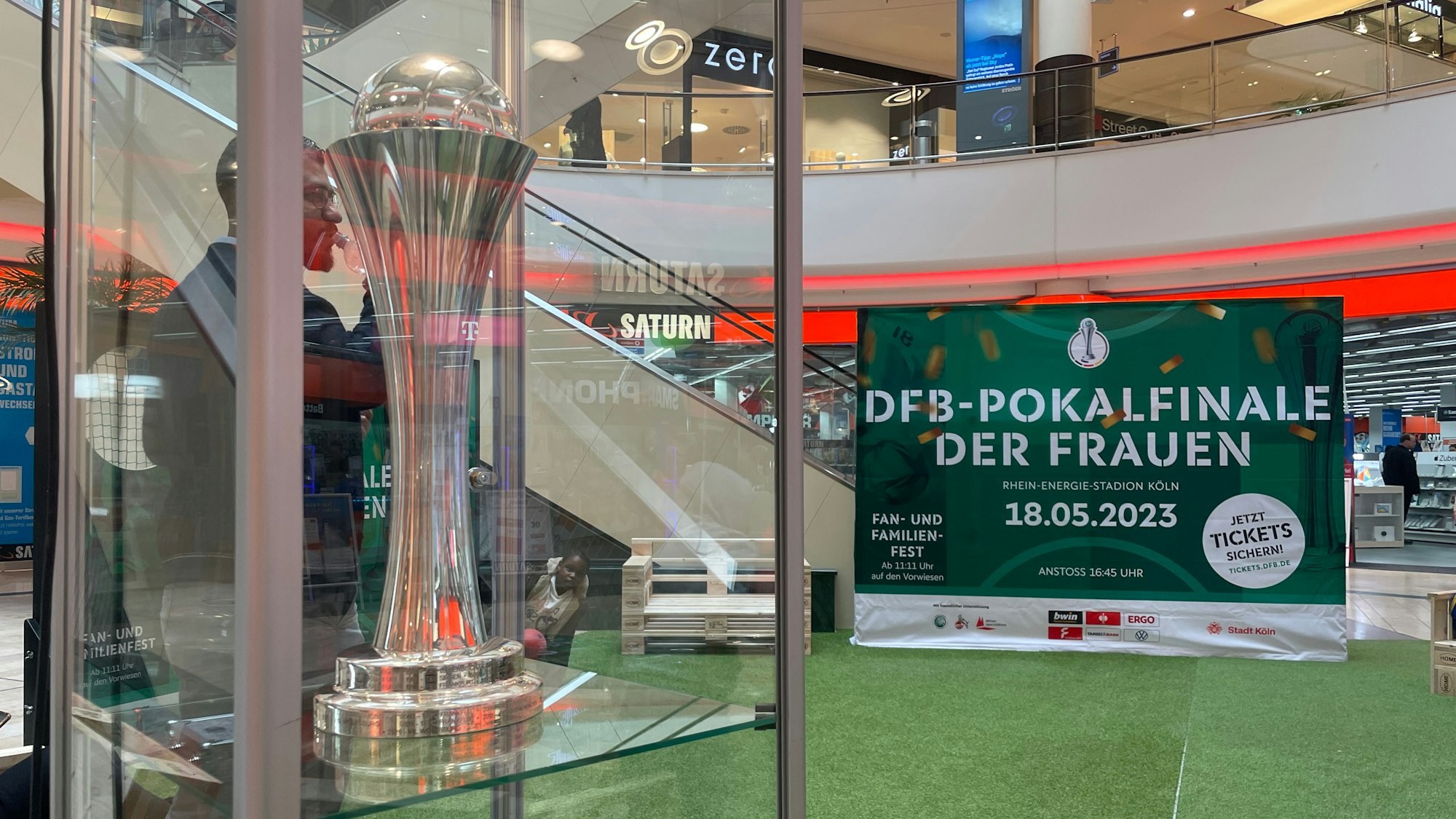 Der DFB-Pokal der Frauen in einer Vitrine. Dahinter ein Aufsteller mit dem Schriftzug "DFB-Pokalfinale der Frauen, 18.05.2023.“