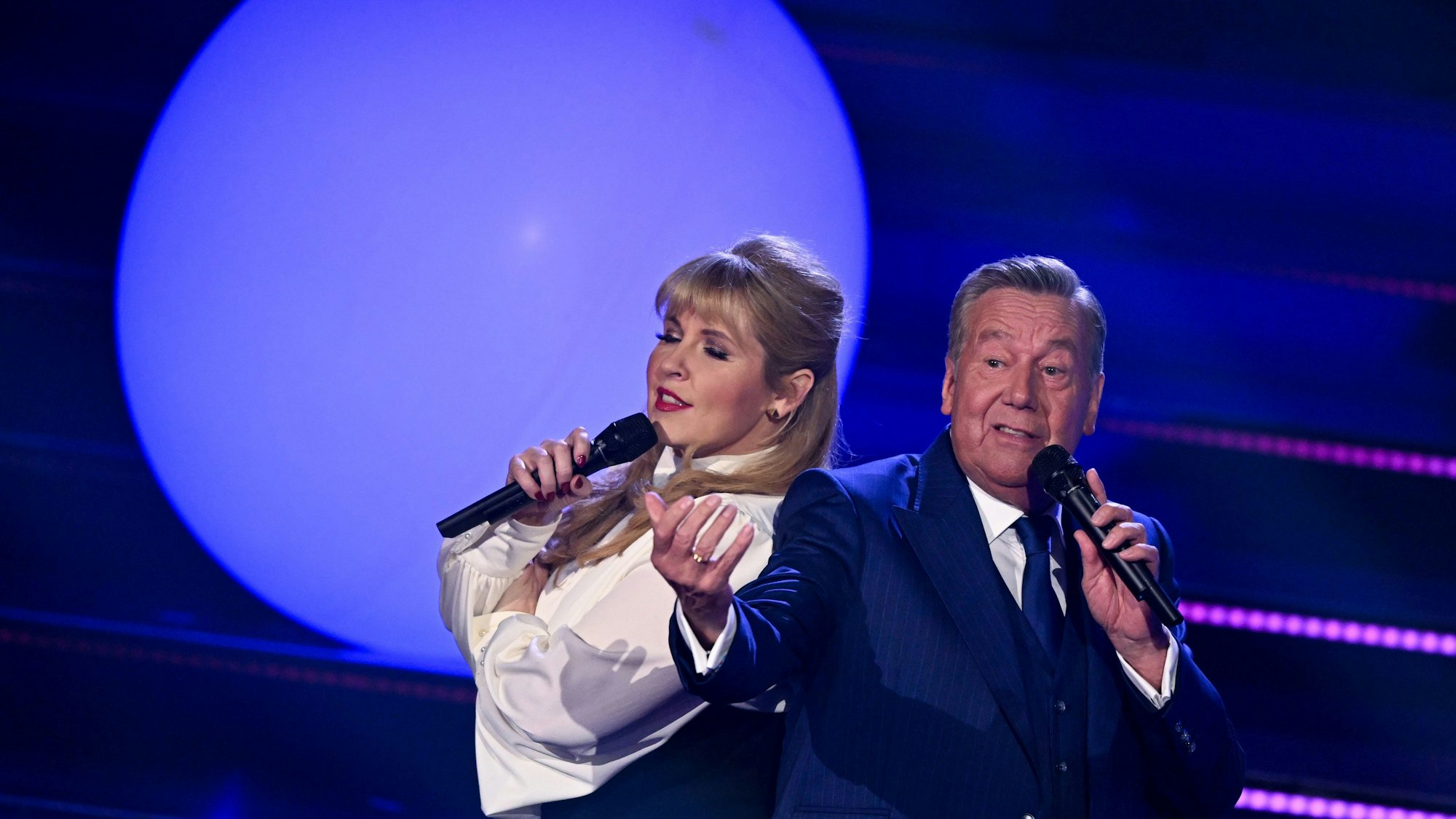 Sängerin Maite Kelly und der deutsche Schlagersänger Roland Kaiser stehen 2022 während der Fernsehshow ·Der große Schlagerabschied· gemeinsam auf der Bühne. Mit der Sendung verabschiedet sich Schlagersänger J. Drews endgültig von der großen Bühne.