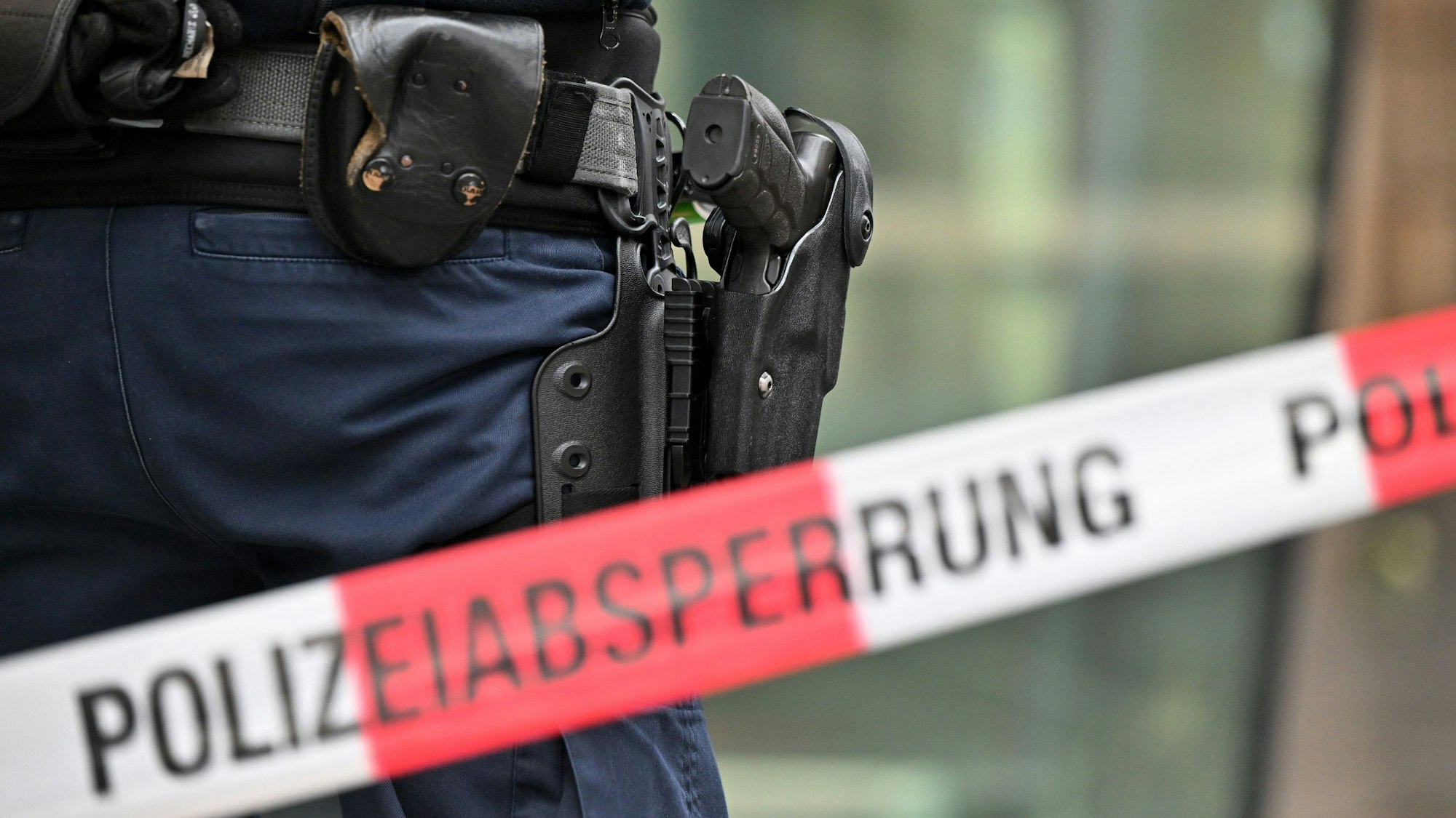 Bewaffnete Bundespolizisten stehen an einer Polizeiabsperrung.