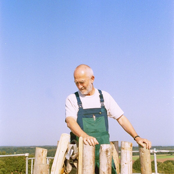 Architekt Peter Zumthor im grünen Overall bei den Bauarbeiten zur Kapelle in Wachendorf